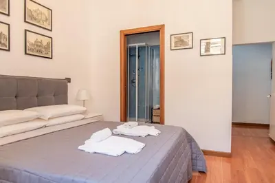 a bedroom with a bed with towels on it at Pura Vida in Rome