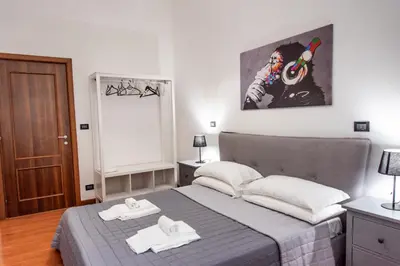 a bedroom with a bed with two towels on it at Pura Vida in Rome