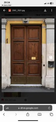 a large wooden door on the side of a building at Pura Vida in Rome