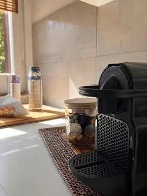 a coffee maker on a kitchen counter with a jar of beans at Casa Fiore in Rome
