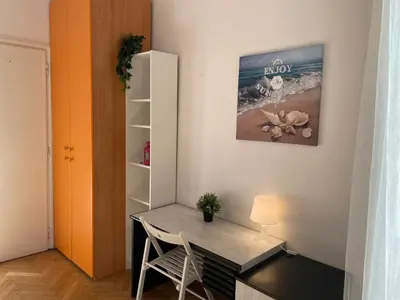 a room with a desk and a table and a shelf at Group Apartment Roma in Rome