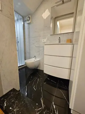 a bathroom with a sink and a toilet and a mirror at THE ONE FRATTINA Apartment in Rome
