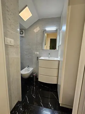 a bathroom with a sink and a mirror at THE ONE FRATTINA Apartment in Rome
