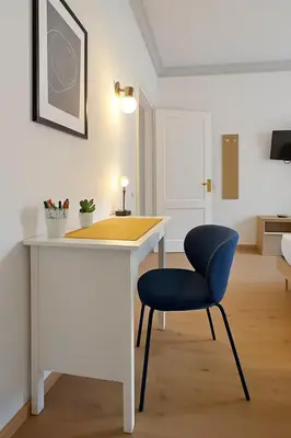 a white desk with a blue chair in a room at Flaminio Luxury - GR HOME in Rome