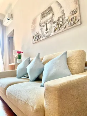 a living room with a couch with blue pillows at Upi-Up Rome Staying in Rome