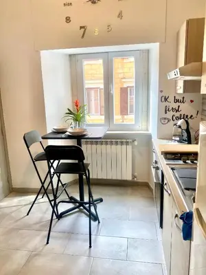 a small kitchen with a table and chairs in it at Upi-Up Rome Staying in Rome