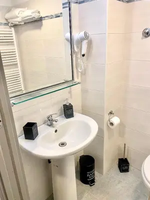 a bathroom with a sink and a mirror at Upi-Up Rome Staying in Rome
