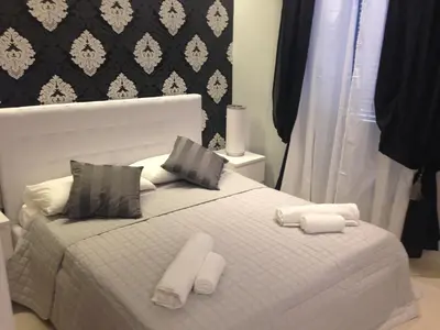 a bedroom with a bed with towels on it at ROMAnce Cosimato Trastevere B&B in Rome
