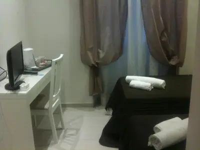 a room with a desk and a bed and a computer at ROMAnce Cosimato Trastevere B&B in Rome