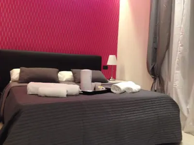 a bedroom with a bed with two towels on it at ROMAnce Cosimato Trastevere B&B in Rome