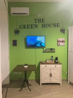 a green room with a table and a green house at The Green House in Rome
