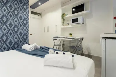 a bedroom with a bed with towels on it at Nina - Tiny Suite in Trastevere in Rome