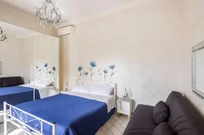a bedroom with two beds and a couch in it at Appartamento per chi ama gustare il caffè in terrazzo in Rome