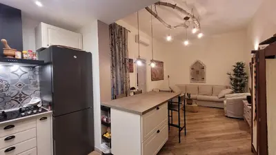 a kitchen with a refrigerator and a living room at casa vacanza vaticano in Rome