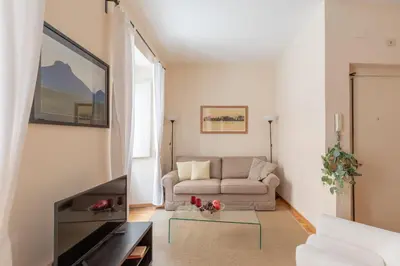 a living room with a couch and a table at iFlat Little & Bright in Trevi in Rome