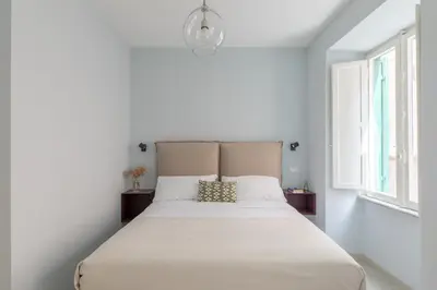 a white bedroom with a large bed in a room at iFlat Lovely in Trevi in Rome
