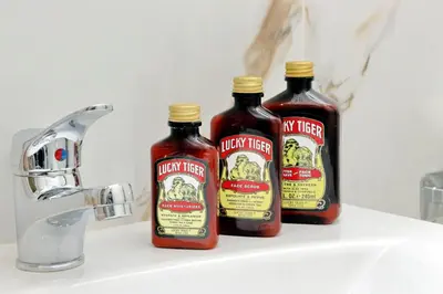 three bottles of hot sauce sitting on a bathroom sink at NuvolHouse in Rome