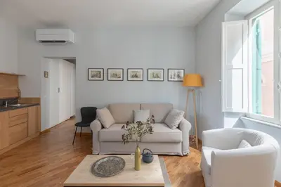 a living room with a white couch and two chairs at iFlat Trevi Charming in Rome