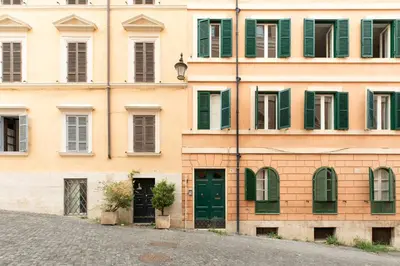 an old building with green doors and windows at iFlat Trevi Charming in Rome
