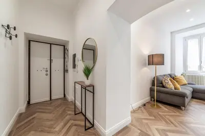 a living room with a couch and a mirror at Private apartment in Rome