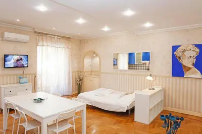 a bedroom with a bed and a table and chairs at Apartment Felice in Rome