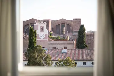 a building with a clock tower on top of it at Suite Deal in Rome