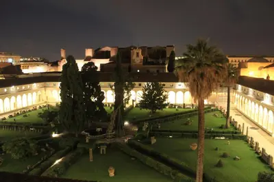 a large building with a garden in front of it at night at Suite Deal in Rome