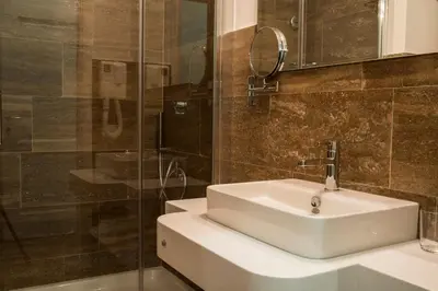 a bathroom with a sink and a glass shower at Suite Deal in Rome