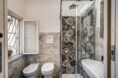 a bathroom with a toilet and a sink and a shower at Casa Magiuli' Navona in Rome