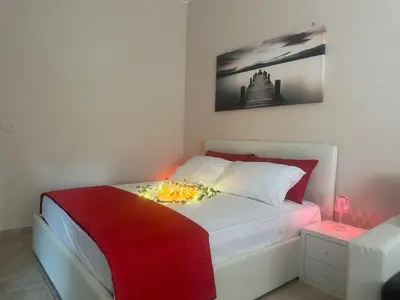 a bedroom with a bed with a flower arrangement on it at Rome Maya Home in Rome