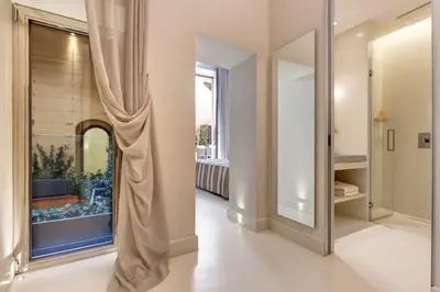 a hallway with a large mirror and a window at Domus Domitia Luxury Living in Rome