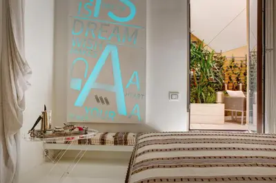 a bedroom with a sign that says dream wish names aana at Domus Domitia Luxury Living in Rome