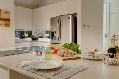 a kitchen with a counter top with a refrigerator at Domus Domitia Luxury Living in Rome