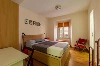 a bedroom with a bed and a table and a desk at GuestHost - Roma Termini Comfy Apartment in Rome