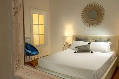a bedroom with a white bed and a mirror at Daplace - Virginia Apartment in Rome