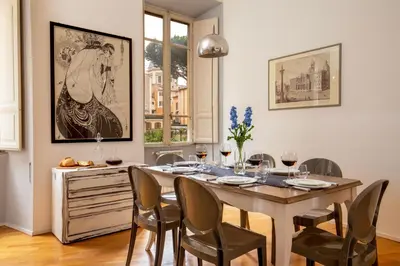 a dining room with a table and chairs at Daplace - Virginia Apartment in Rome