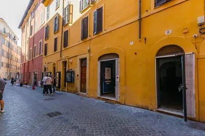 a street in a city with a yellow building at Laurina deluxe apartment in Rome