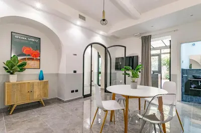 a dining room with a table and chairs at Laurina deluxe apartment in Rome