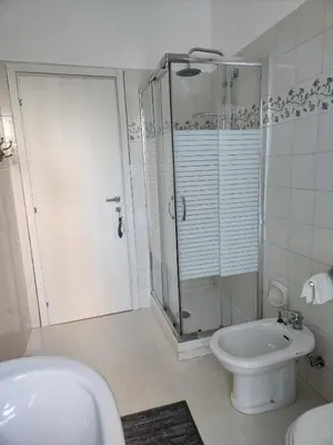 a bathroom with a shower and a toilet and a sink at CHEZ NOUS in Rome
