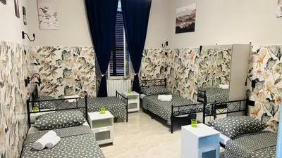 a room with three beds and a wall with a mural at Soha's Holiday in Rome