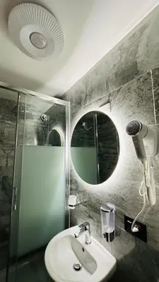 a bathroom with a sink and a shower and a mirror at Soha's Holiday in Rome