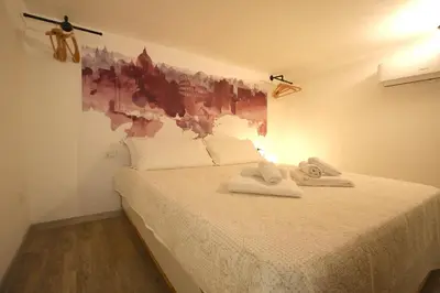 a bedroom with a bed with towels on it at Monti Holiday House in Rome