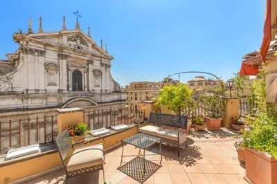 a view of a balcony with chairs and a building at Casa Colonna, a Burghesius home in Rome