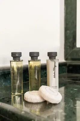 a couple of bottles sitting on a bathroom counter at Casa Colonna, a Burghesius home in Rome