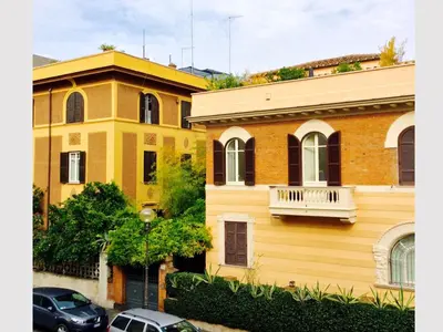 a couple of buildings with cars parked in front of them at Aldebaran in Rome