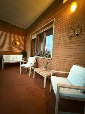 a porch with chairs and a table and a window at Vatican luxury - private parking free - meospiti luxury in Rome