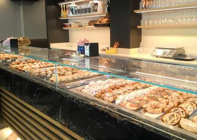 a bakery filled with lots of different types of donuts at Maison Ammiragli Vatican Rooms in Rome