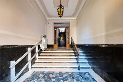 a hallway with stairs and a chandelier at suity I monkeys apartment in Rome