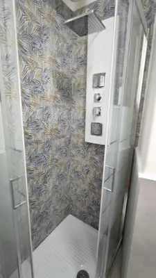 a shower with a glass door in a bathroom at VATICAN GREEN GARDEN in Rome