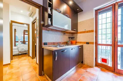 a kitchen with a sink and some windows at Alle Mura Aurelie Apartment in Rome